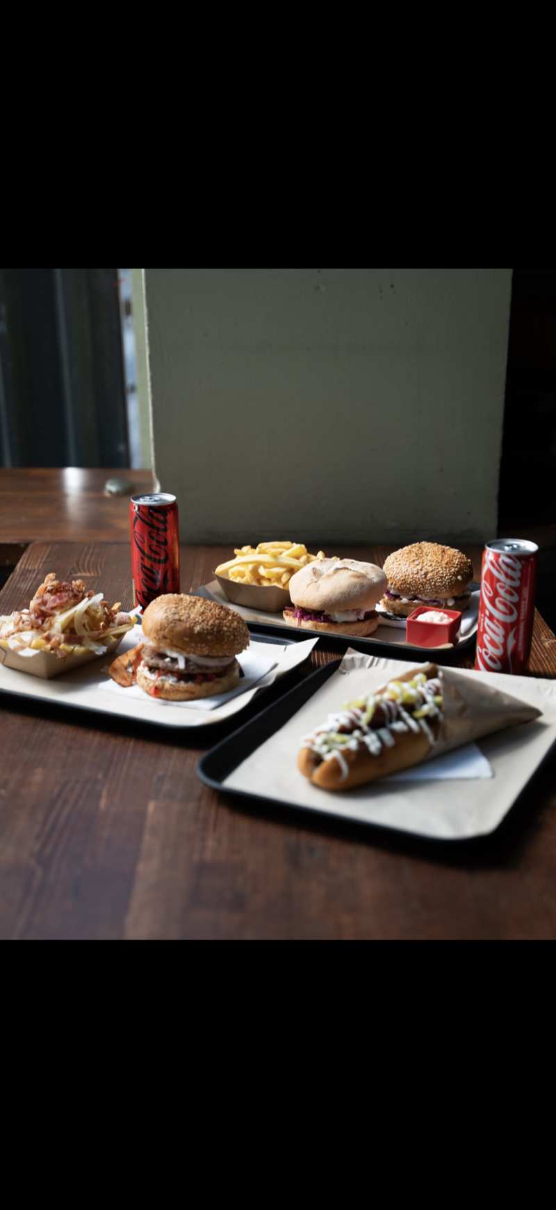 FOOD Str burger wrapped in branded paper with fries