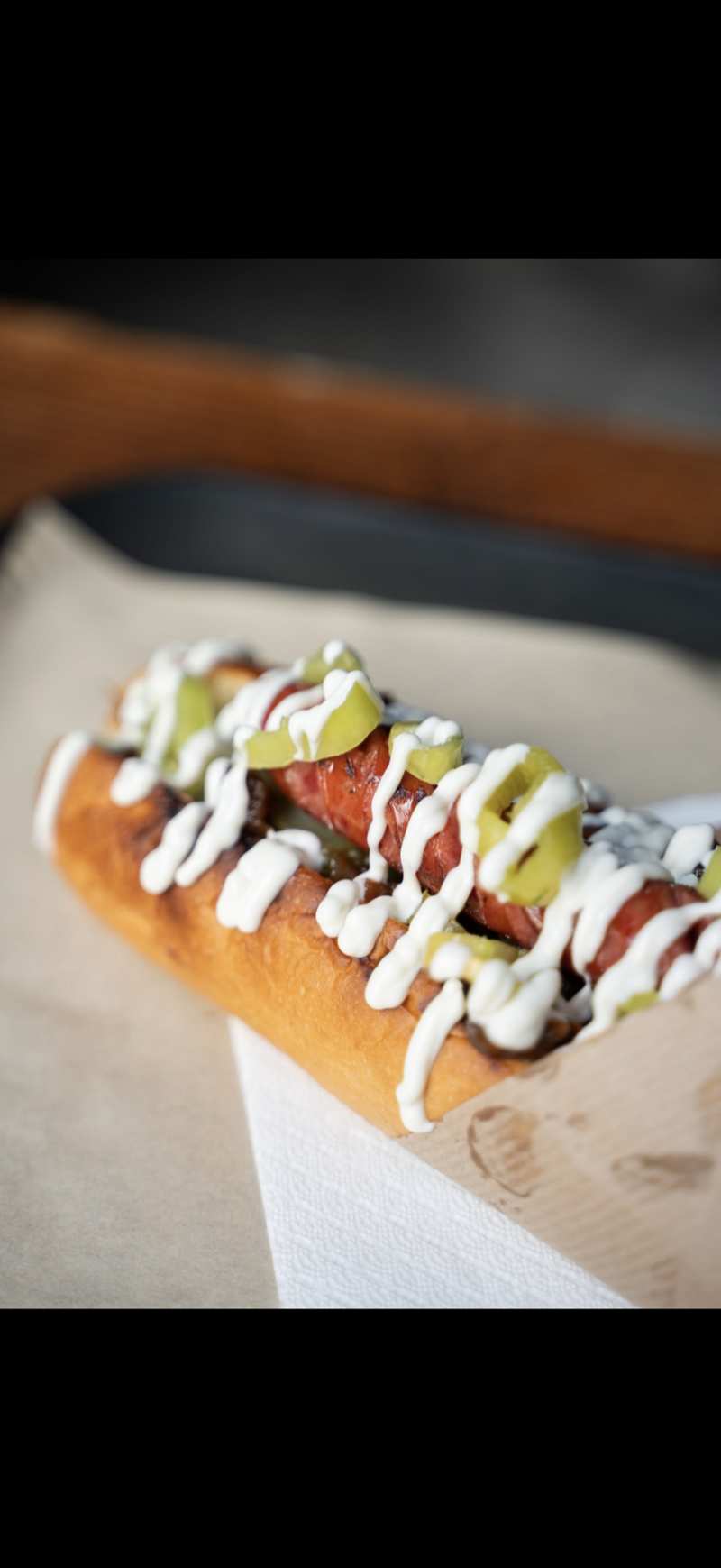 Hand dipping a crispy fry into mayo sauce at FOOD Str