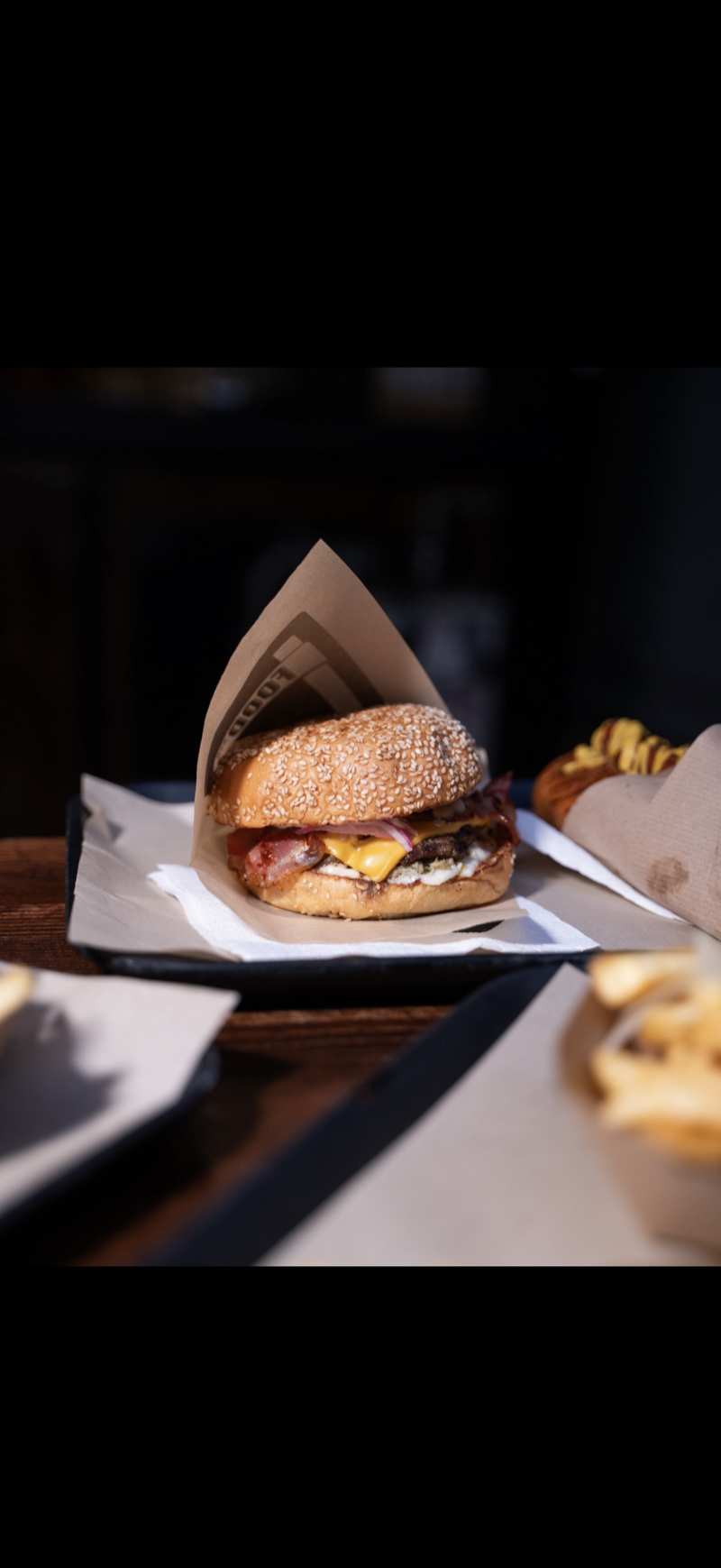 FOOD Str table spread with burgers hot dogs fries and drinks